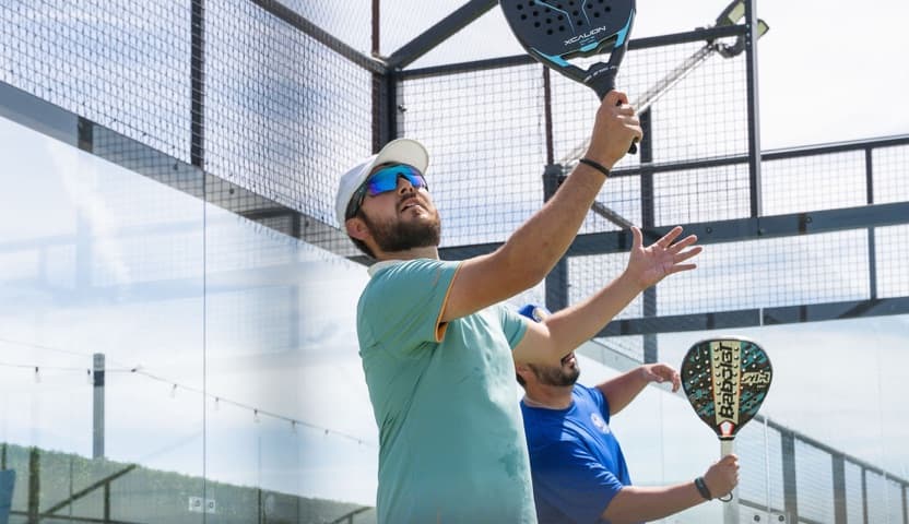 Two players on a padel court during a match