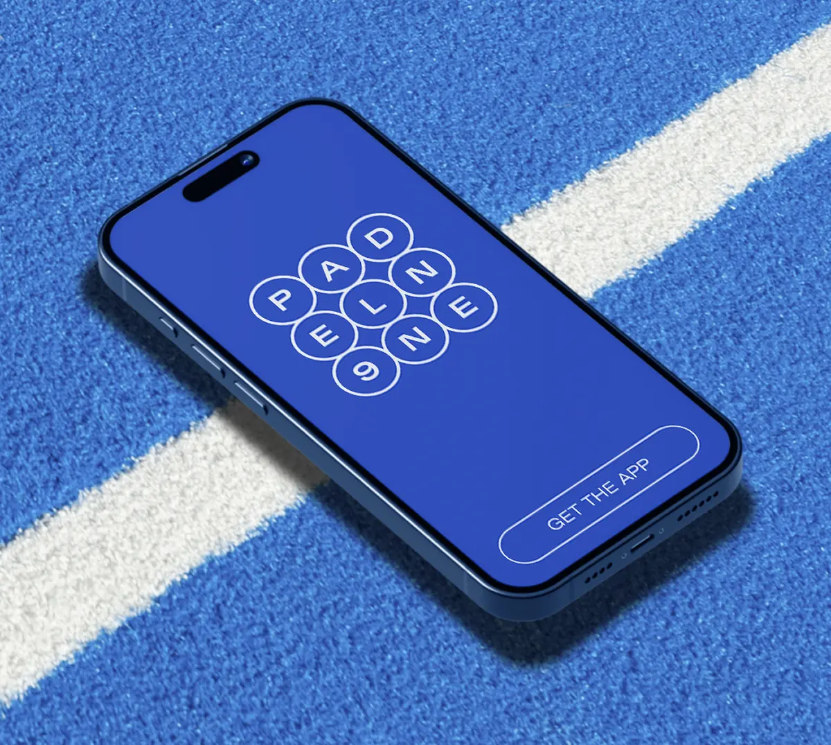 The P9 app on a phone lying on a blue padel court